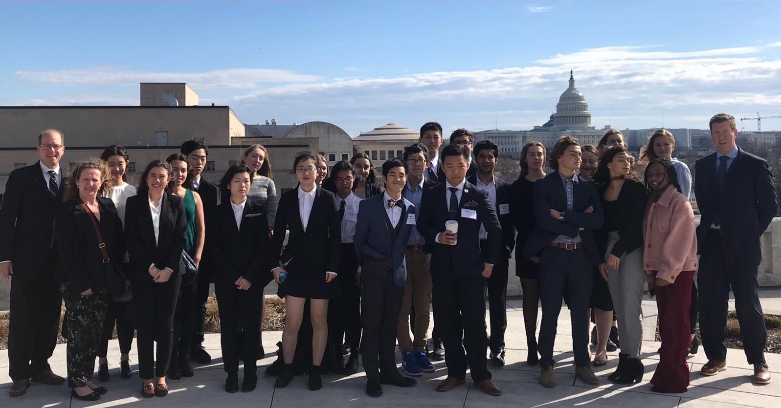 Group photo of students outside a government buliding