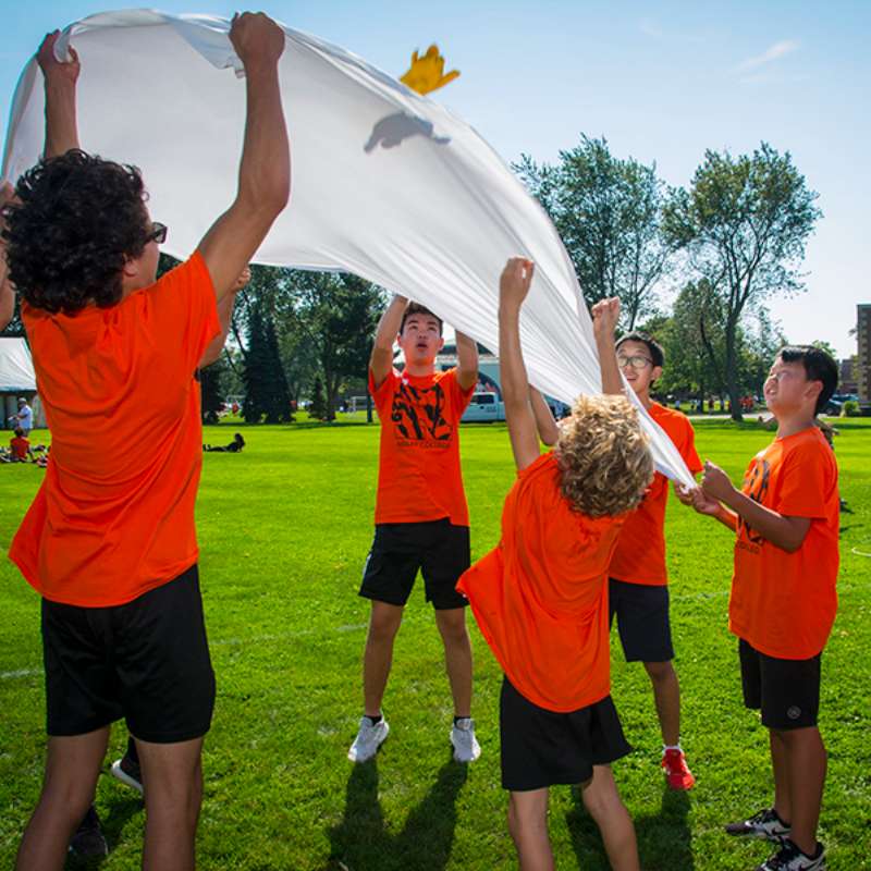 Children outside with parachute